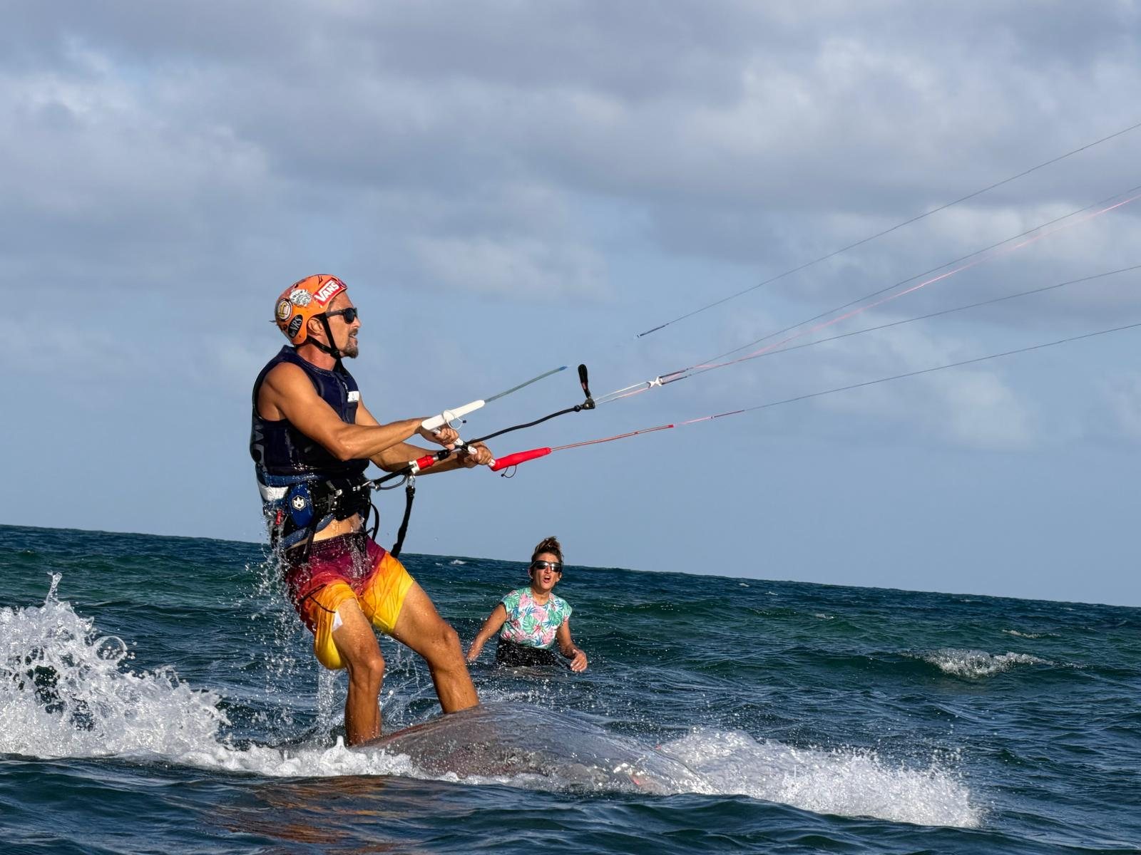 Sophie coaching a beginner in waist-deep water