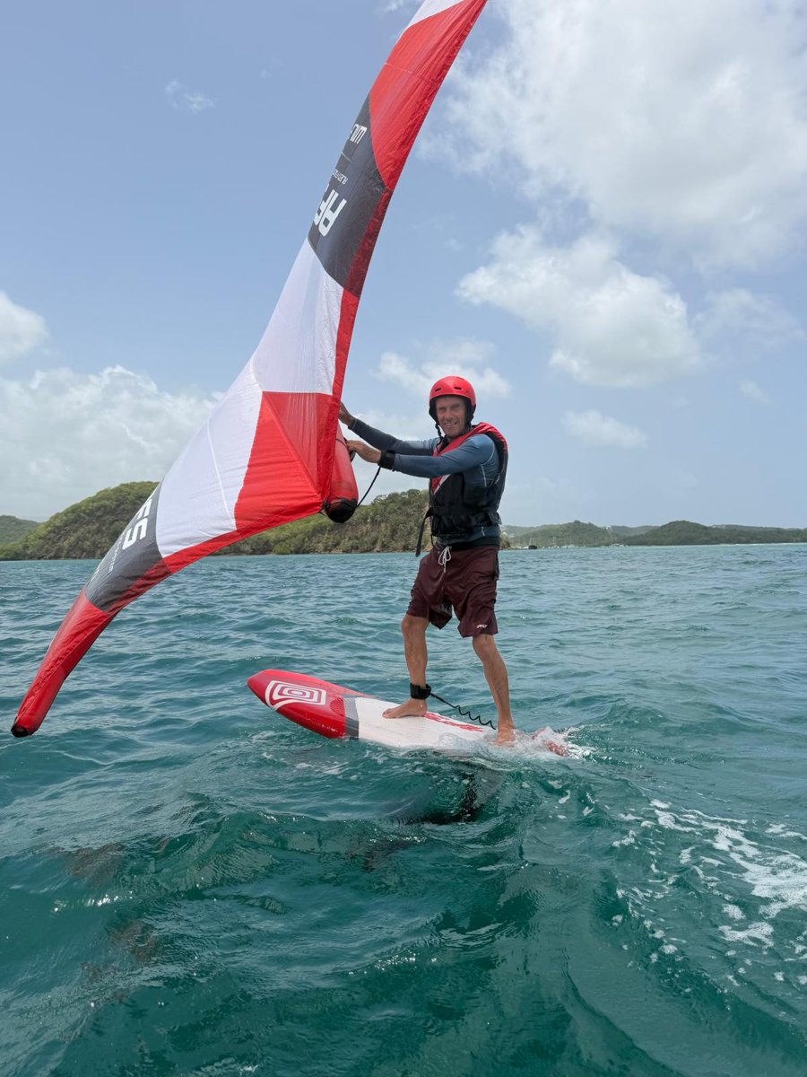 Andi wingfoiling with a red wing