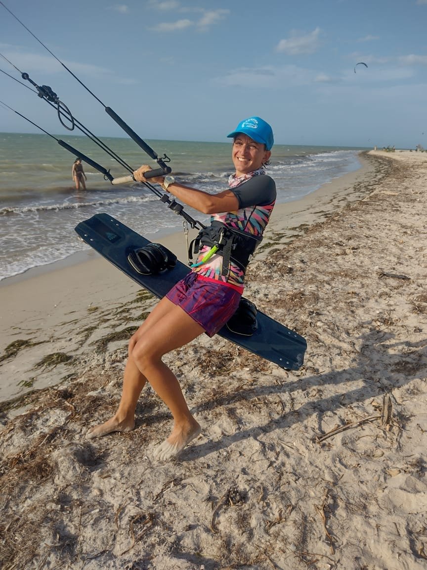 Sophie on the beach with her kite and board