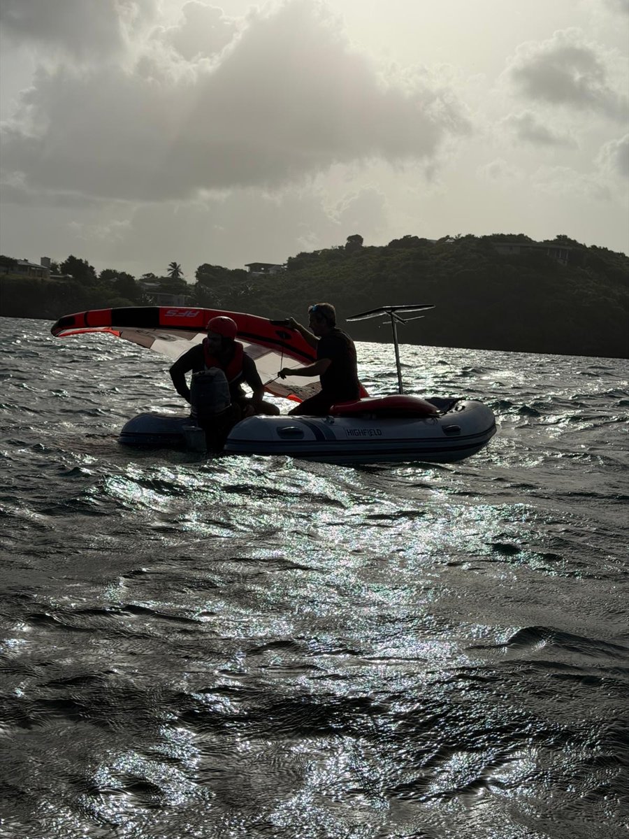 Andi and a student with the wing in the dinghy at sunset